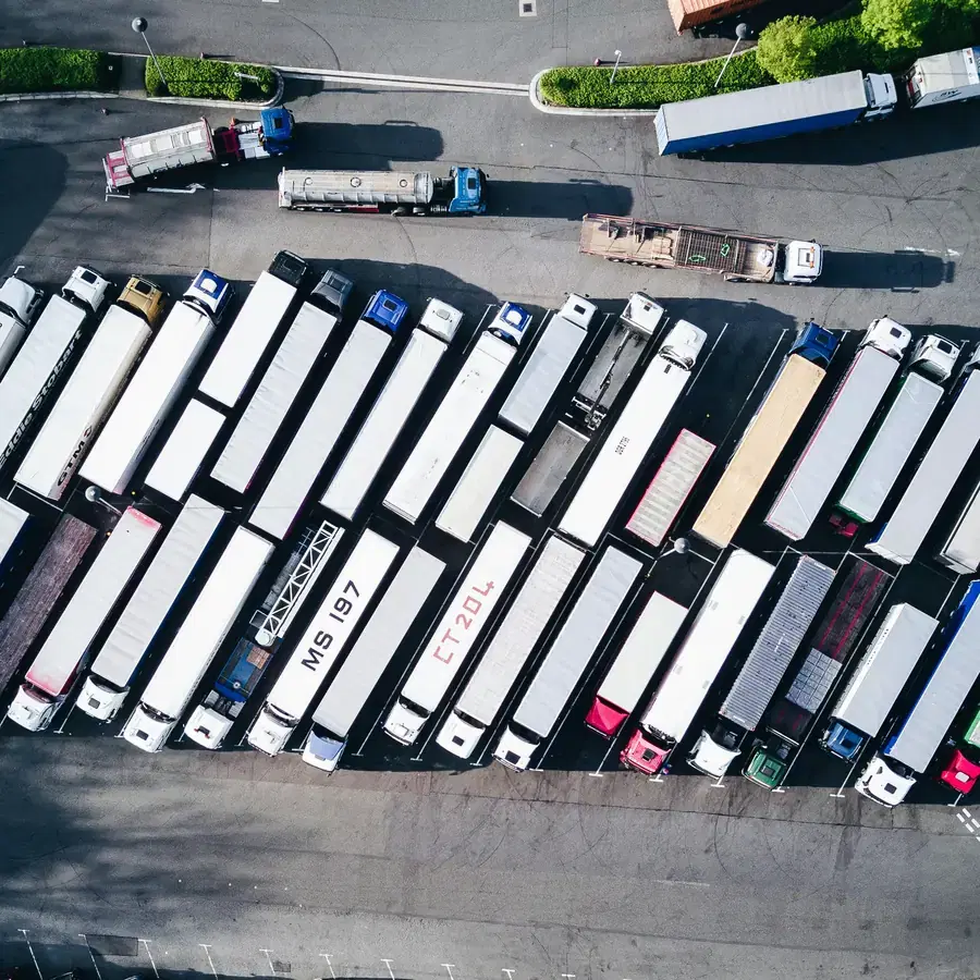 Aerial view of electric cargo vehicles lined up at a logistics yard